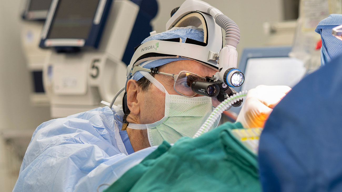 Dr. James Wudel performing open heart surgery to repair two leaky heart valves.