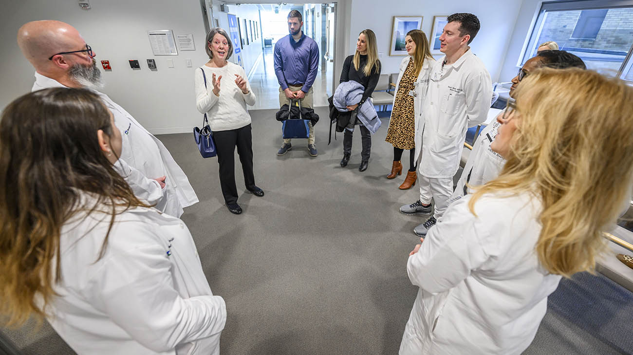 Laura at Cleveland Clinic main campus reuniting with caregivers who cared for her when she had a severe case of COVID-19. 