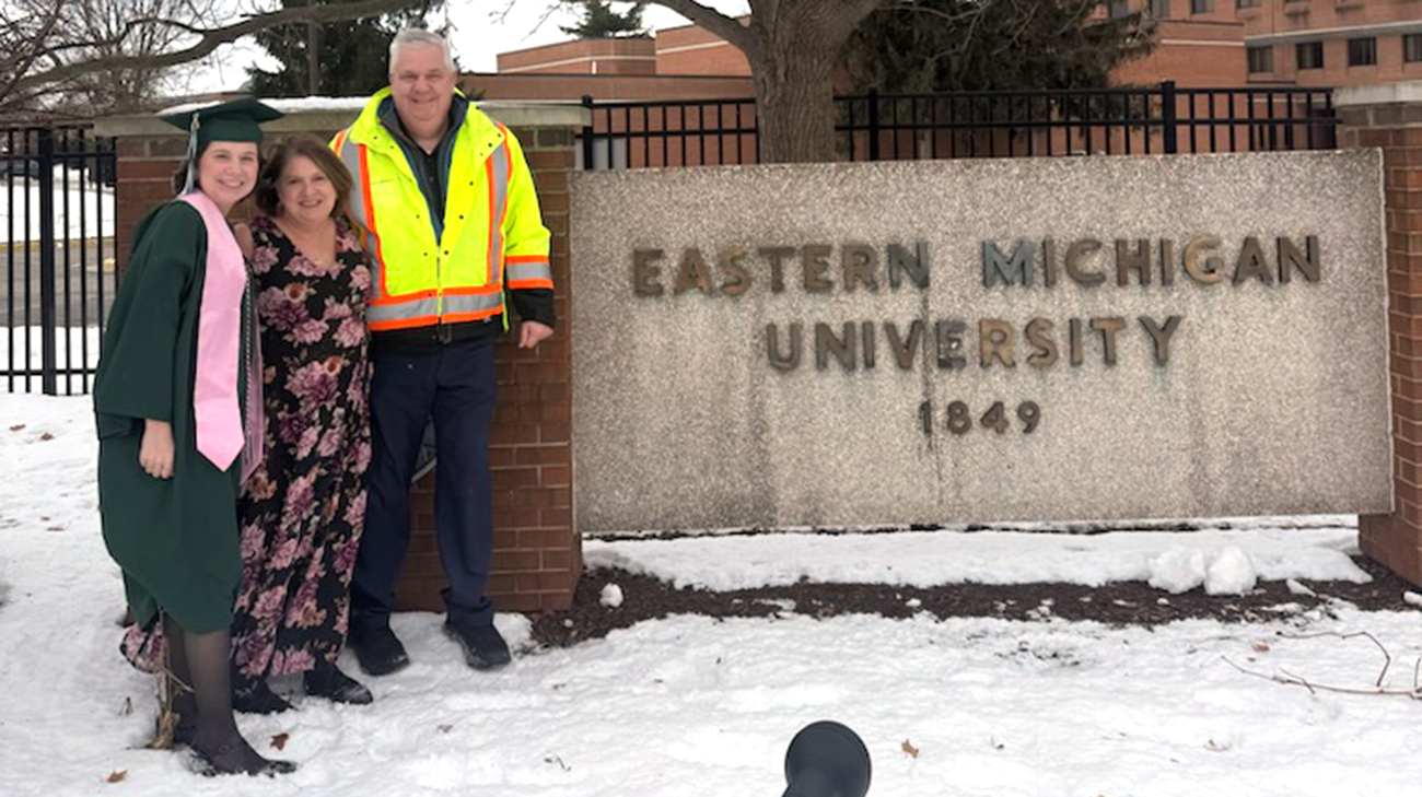 Emma with her parents after graduating from Eastern Michigan University. 