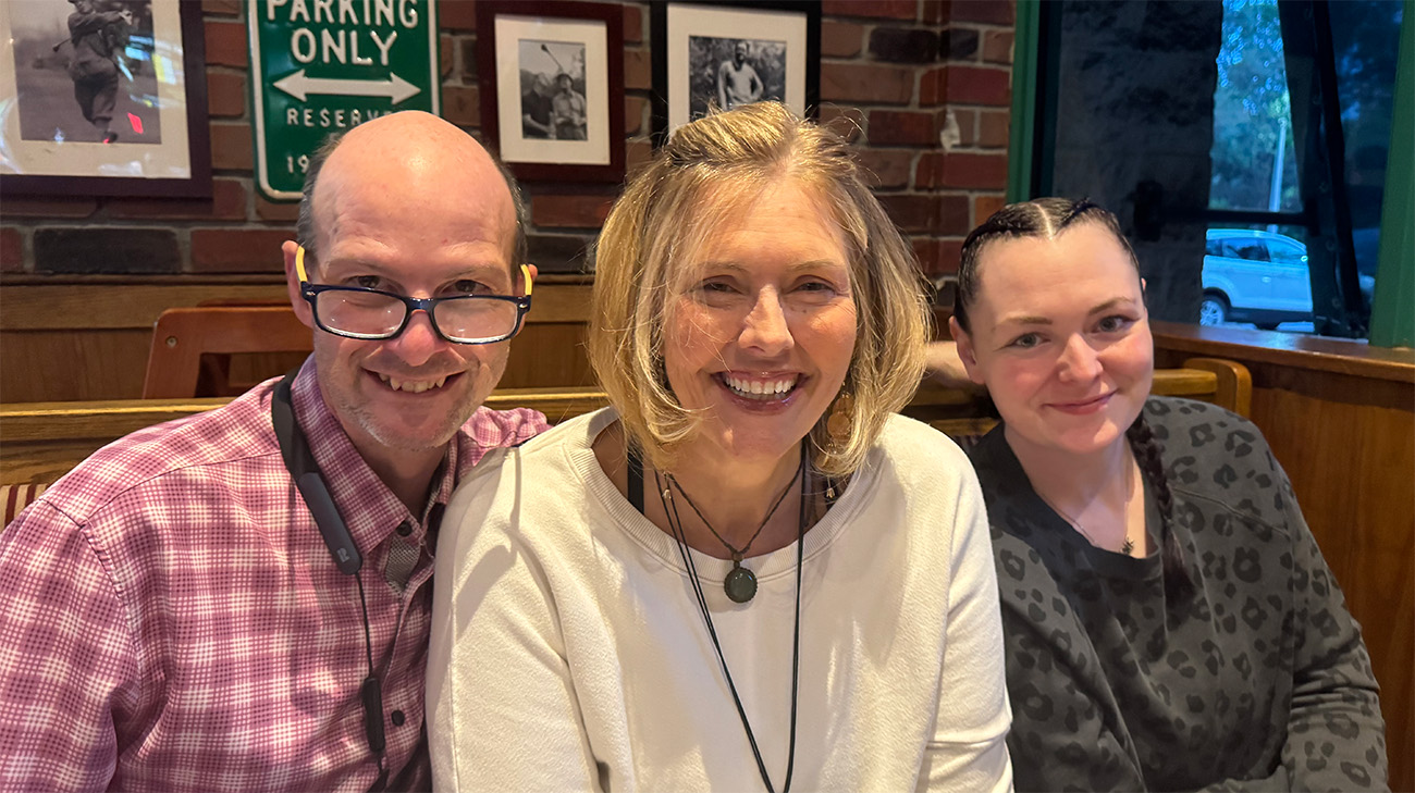 Traci Seely (center) with husband Jim (left) and daughter Adrianne (right)