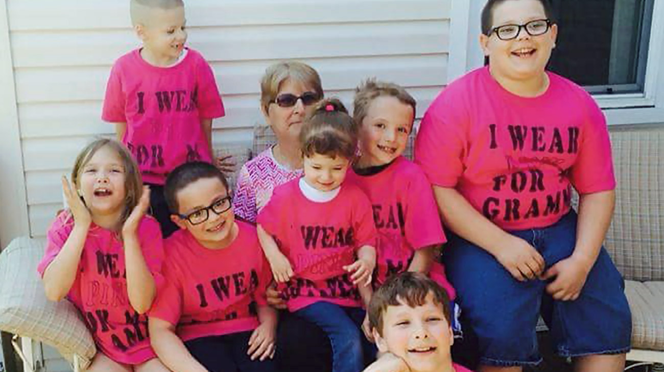 Jane with nine of her 19 grandkids who all made shirts to support her during breast cancer treatment