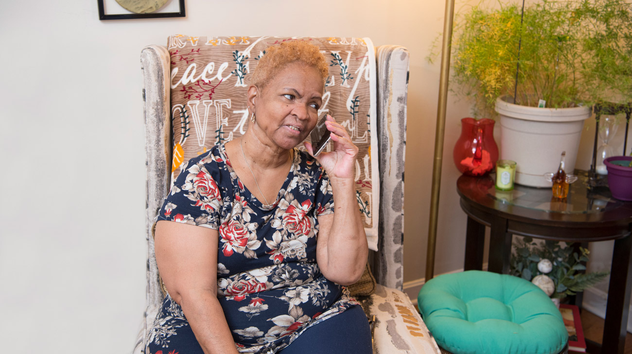 Cheryl West talking on the phone in her living room