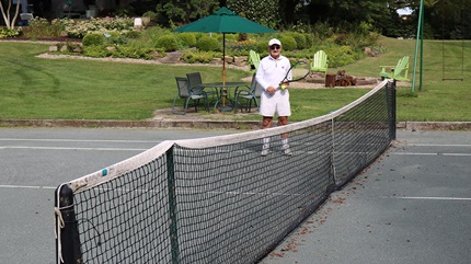 Evan Morris standing on a tennis court holding a racquet. (Courtesy: Cleveland Clinic)