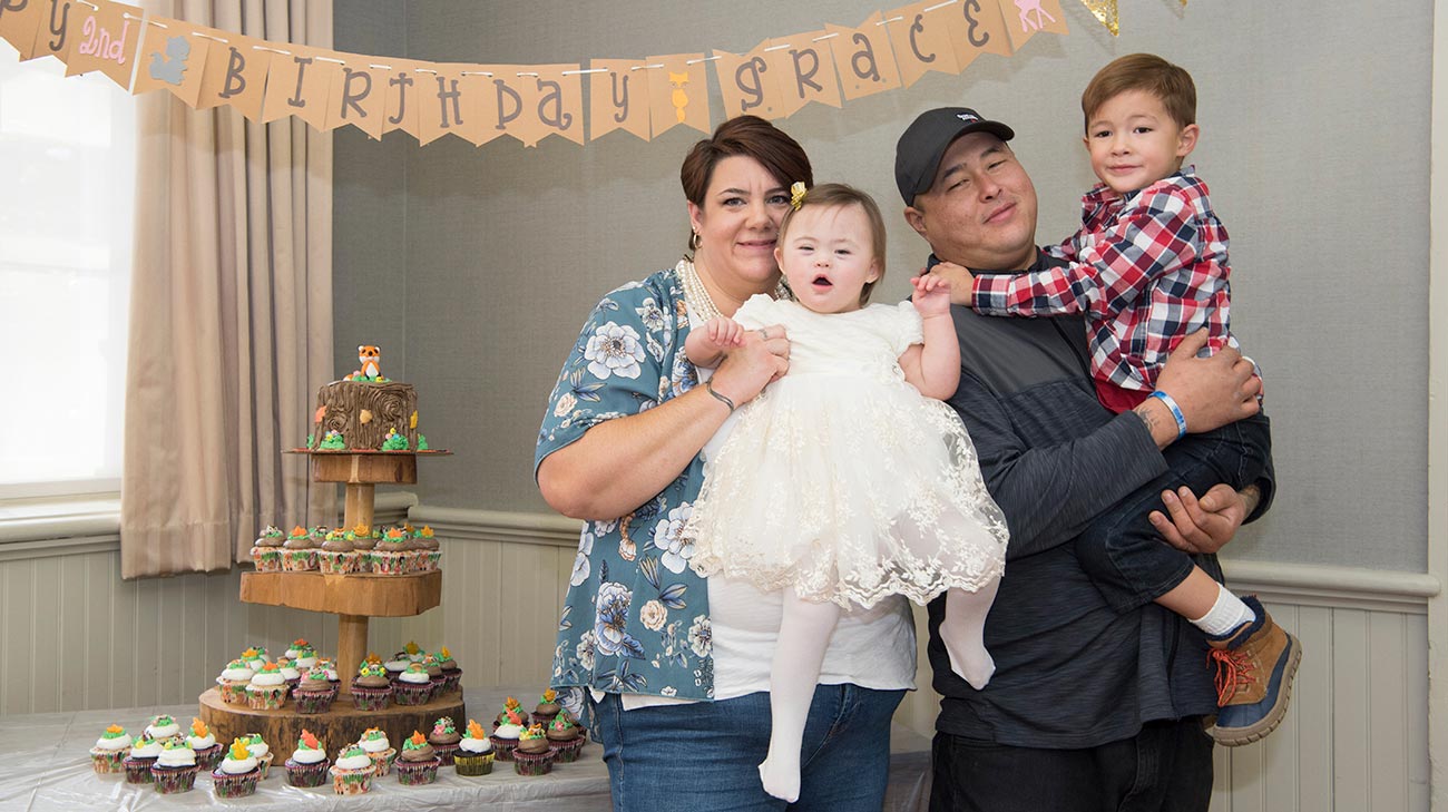 Grace, with her mother, Valerie, father, Josh, and brother, Robert, at her second birthday party.