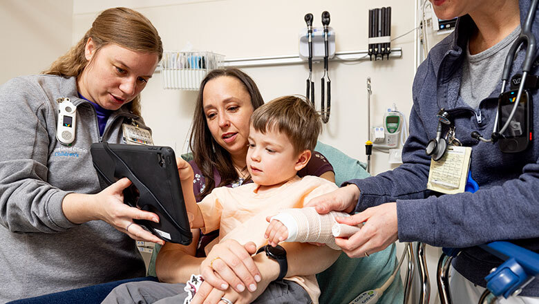 Cleveland Clinic Caregivers working with a child patient an their mother in the emergency department.