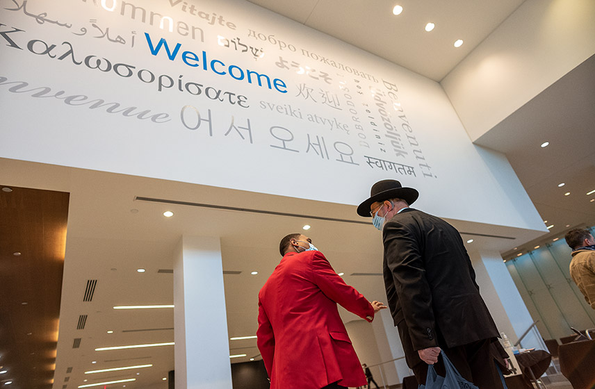 Redcoat greeting patient under welcome sign