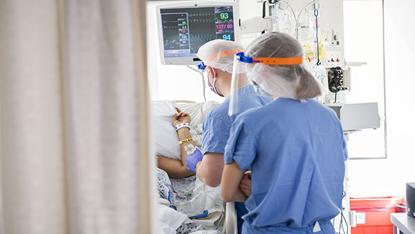 Two caregivers with a patient.