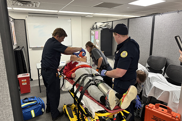 Paramedics loading patient onto stretcher