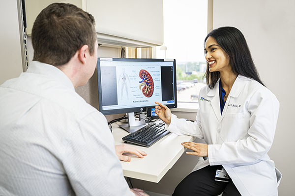 Two Cleveland Clinic physicians looking over an illustration.
