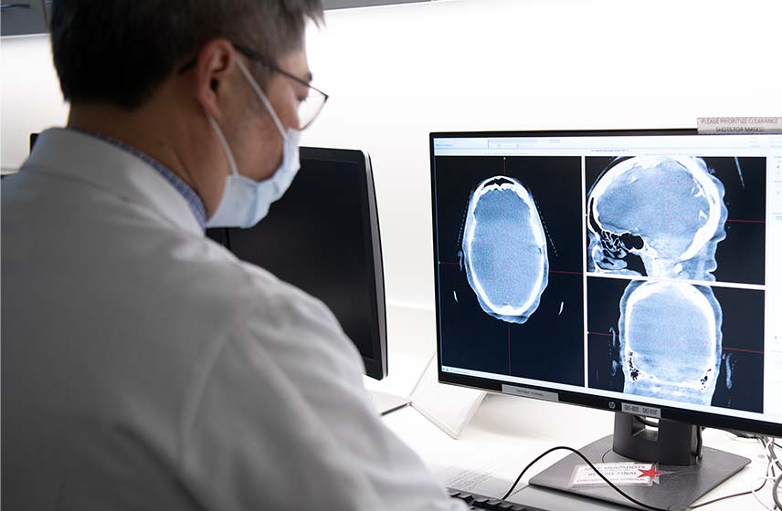 A caregiver looking at a cranial scan.