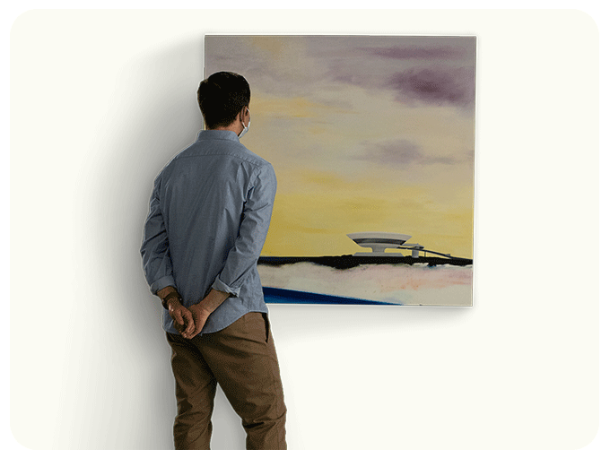 man looking at art on wall