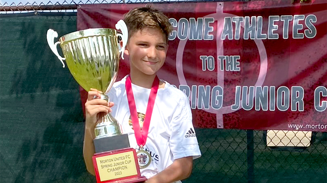 Monica's grandson holding the first-place trophy after a soccer tournament. 